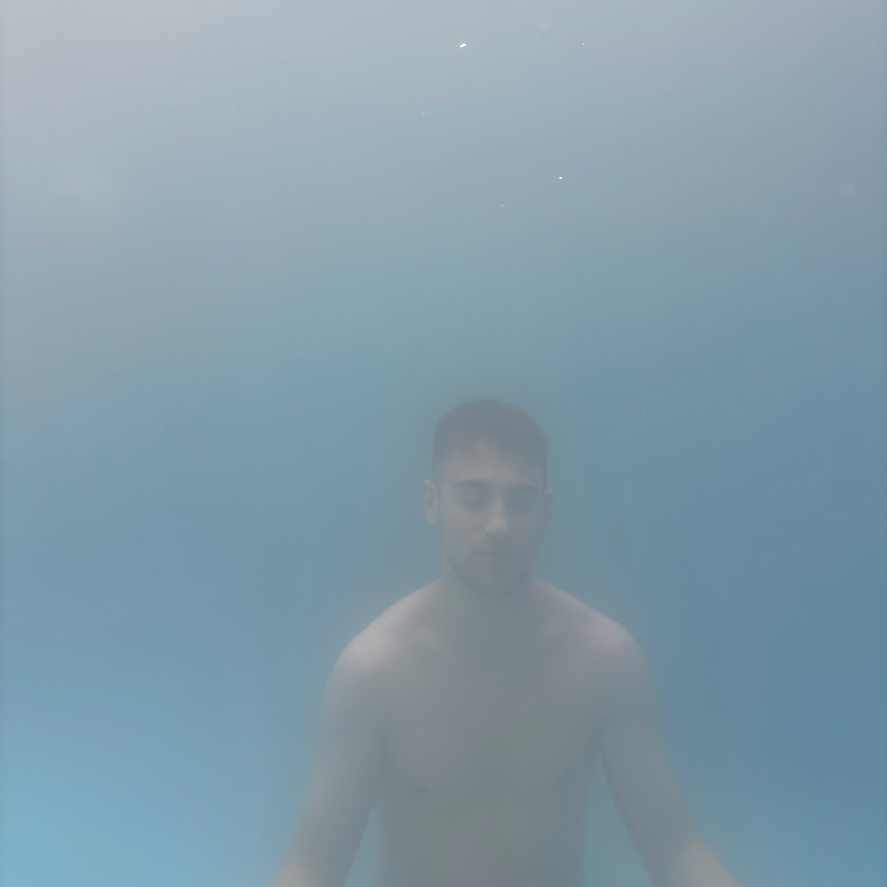 Artwork: Louis Joseph submerged in pale blue water.
